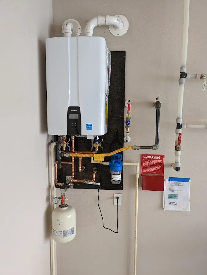 Professional plumber installing copper piping in a Rice home